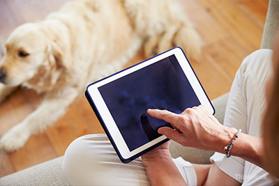 Woman on tablet with dog