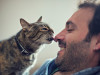 cat licking man
