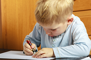 Little boy writing a letter